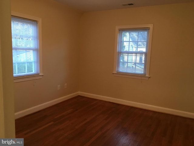 empty room with dark hardwood / wood-style floors