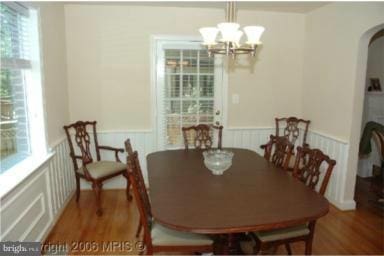 dining area with a chandelier and wood-type flooring