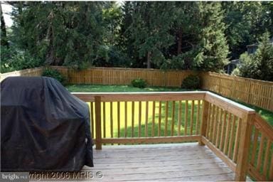 wooden terrace featuring a grill