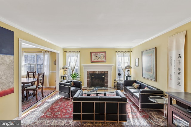 living room with a fireplace, crown molding, and wood finished floors