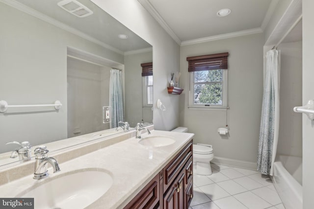 bathroom featuring toilet, tile patterned flooring, ornamental molding, and a sink