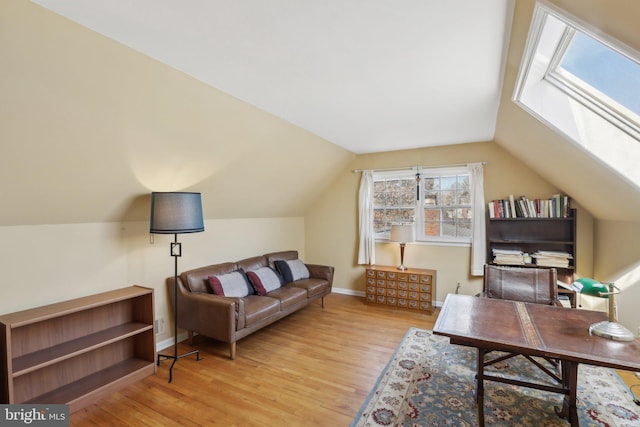 home office with lofted ceiling, wood finished floors, and baseboards