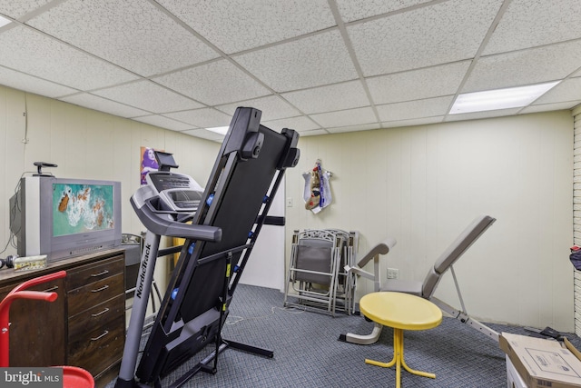 exercise room featuring a drop ceiling