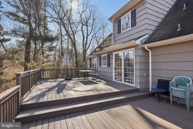 wooden terrace featuring outdoor dining space