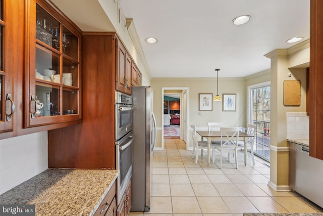 kitchen featuring light tile patterned flooring, backsplash, light stone countertops, and crown molding