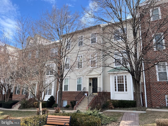 townhome / multi-family property featuring brick siding