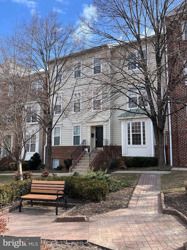 view of property with brick siding