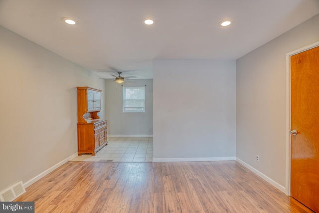 spare room with ceiling fan and light hardwood / wood-style floors