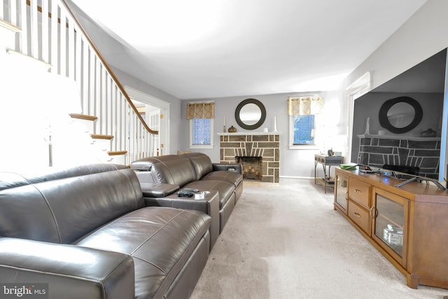 living room with light carpet, a fireplace, stairway, and baseboards