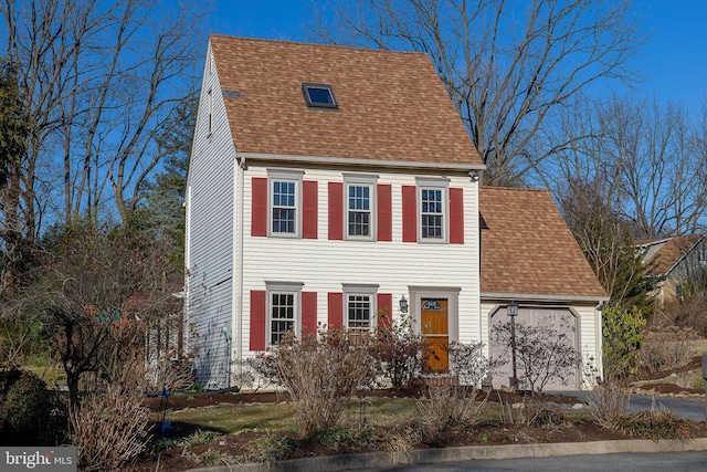 view of front of home with a shingled roof and a garage