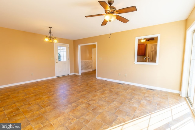 spare room featuring a sink, visible vents, and baseboards