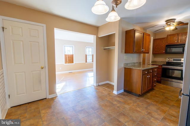 kitchen with light stone counters, electric stove, brown cabinets, and black microwave