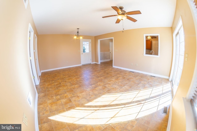 spare room with visible vents, ceiling fan with notable chandelier, baseboards, and a sink