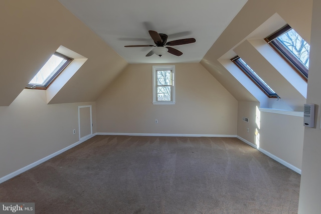 bonus room featuring baseboards, carpet floors, lofted ceiling, and a ceiling fan