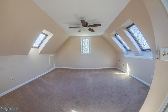 bonus room featuring baseboards, carpet, a ceiling fan, and vaulted ceiling