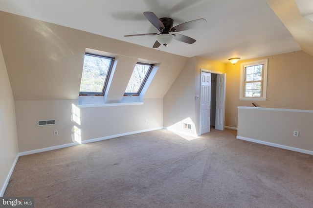 bonus room featuring visible vents, baseboards, carpet floors, and vaulted ceiling