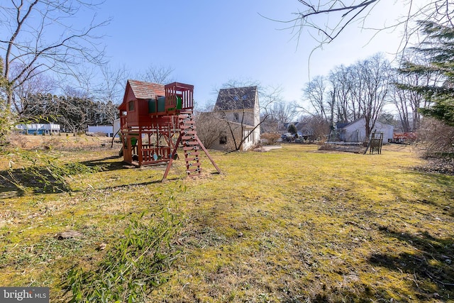 view of yard with a trampoline and a playground