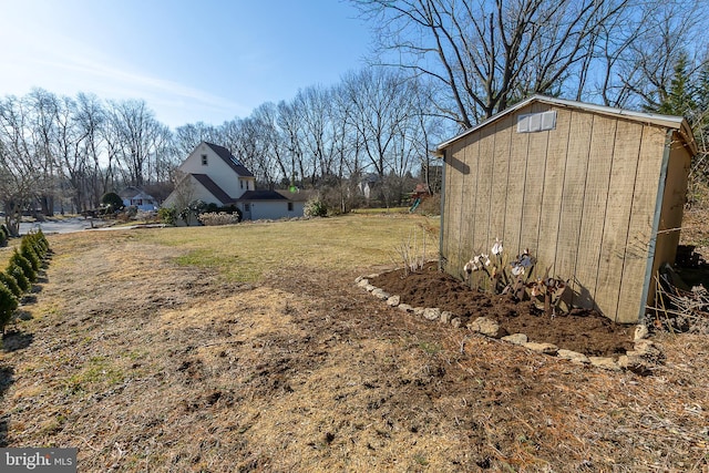 view of yard featuring a storage unit and an outbuilding