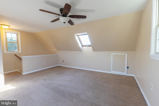 additional living space with vaulted ceiling, baseboards, and carpet floors