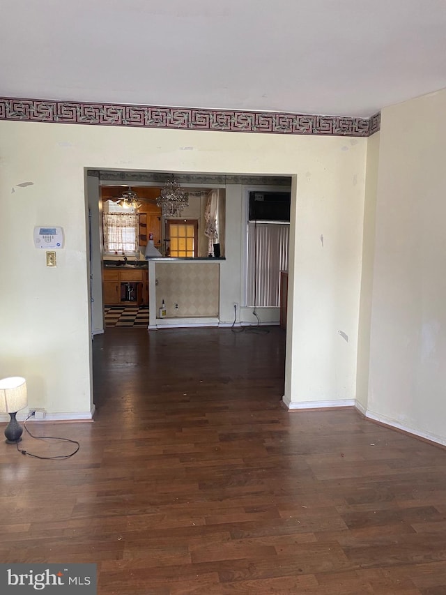 empty room with dark hardwood / wood-style flooring and sink