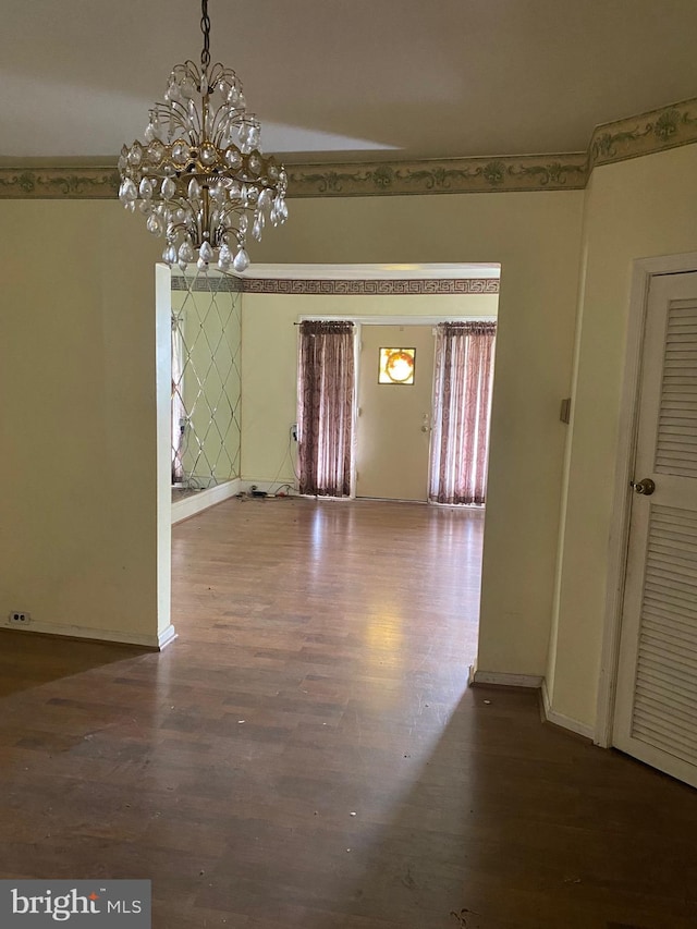 entryway featuring a notable chandelier and dark hardwood / wood-style floors