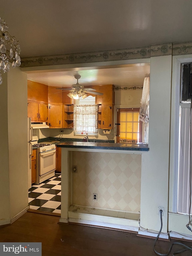 kitchen featuring sink, ceiling fan, white appliances, and kitchen peninsula