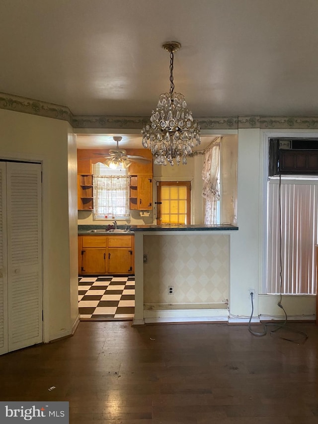 kitchen with sink, dark wood-type flooring, and pendant lighting