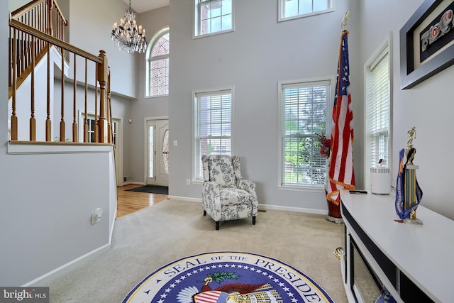 5816 Rockburn Woods Way, Elkridge, MD 21075 - sitting room with light carpet, a towering ceiling, and a notable chandelier