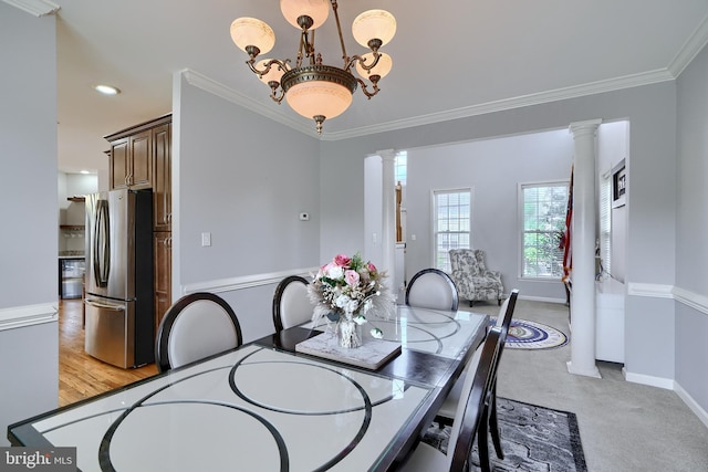5816 Rockburn Woods Way, Elkridge, MD 21075 - dining space featuring a notable chandelier, crown molding, ornate columns, and light colored carpet
