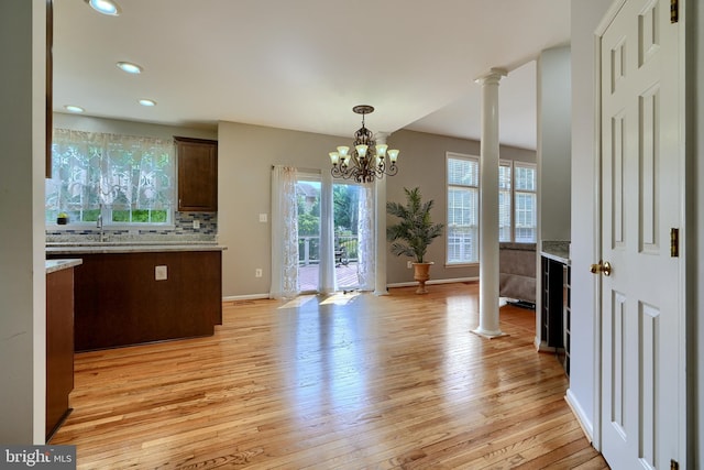 5816 Rockburn Woods Way, Elkridge, MD 21075 - interior space featuring decorative columns, sink, an inviting chandelier, and light hardwood / wood-style floors
