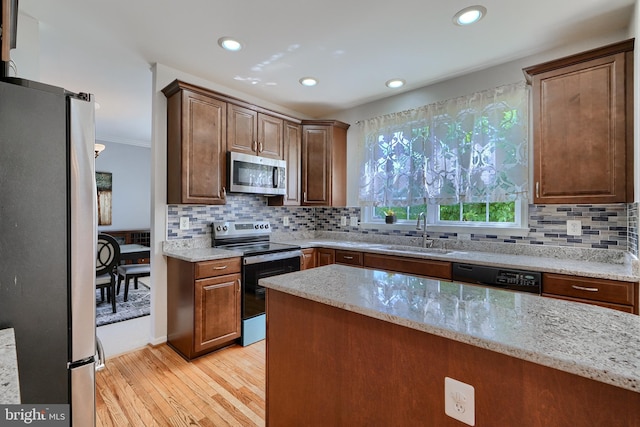 5816 Rockburn Woods Way, Elkridge, MD 21075 - kitchen with sink, stainless steel appliances, backsplash, and light stone counters