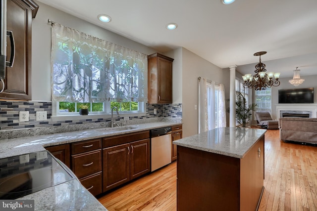 5816 Rockburn Woods Way, Elkridge, MD 21075 - kitchen with sink, light stone counters, light wood-type flooring, dishwasher, and a kitchen island
