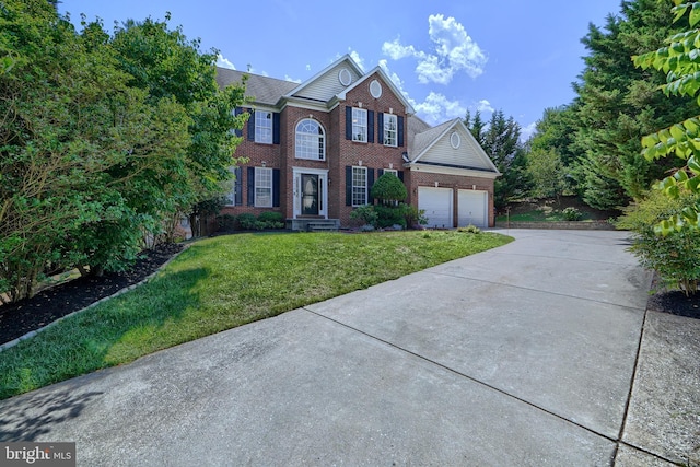 view of front of house with a front yard and a garage