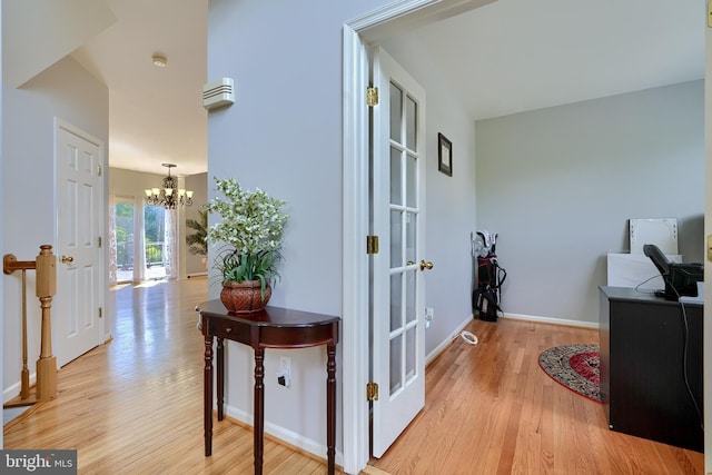 5816 Rockburn Woods Way, Elkridge, MD 21075 - hallway featuring a notable chandelier and light hardwood / wood-style floors