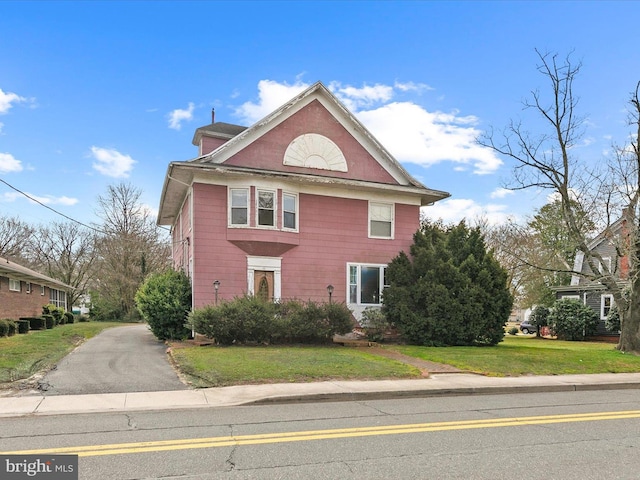 view of property exterior with a lawn