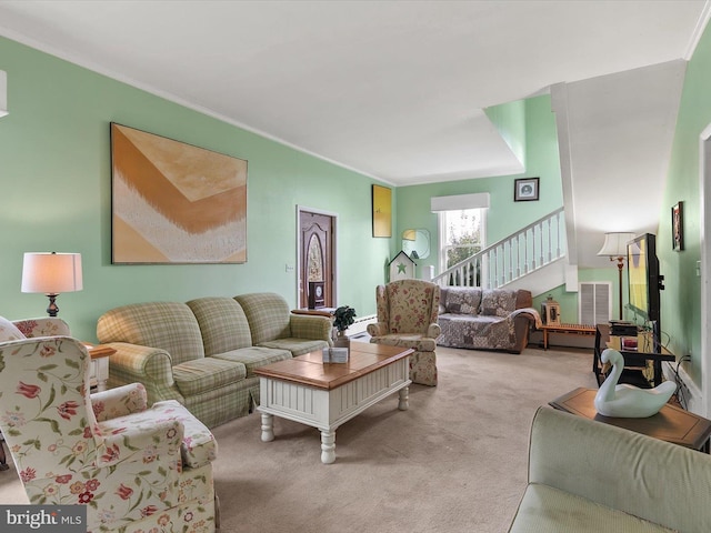 living room featuring ornamental molding, light carpet, visible vents, and stairs