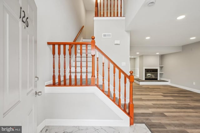 stairway featuring wood-type flooring