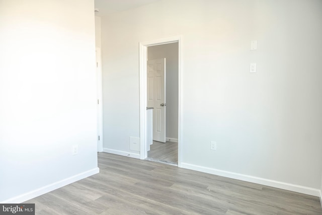 unfurnished room featuring baseboards and wood finished floors