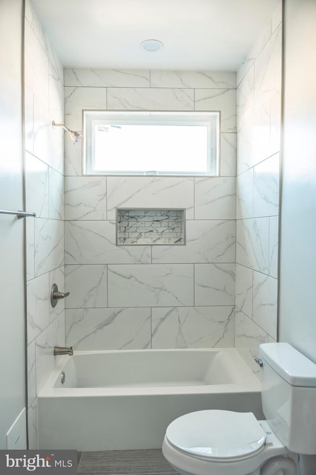 bathroom with shower / washtub combination, a wealth of natural light, and toilet