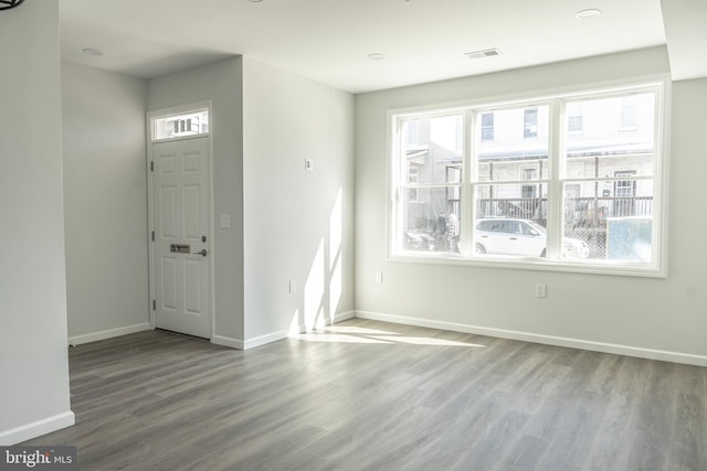 entryway with visible vents, baseboards, and wood finished floors