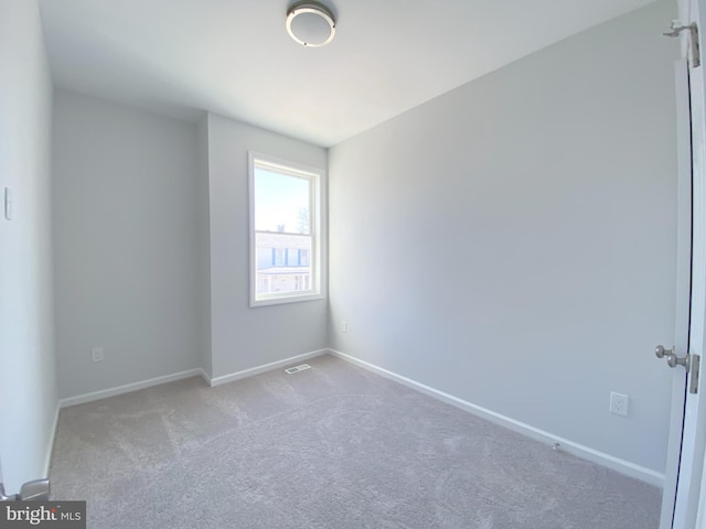 carpeted empty room with visible vents and baseboards