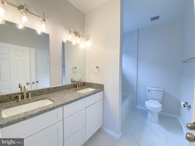 full bath with toilet, double vanity, visible vents, and a sink