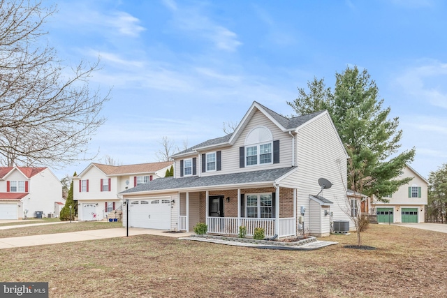 traditional-style house with driveway, central AC unit, an attached garage, covered porch, and brick siding