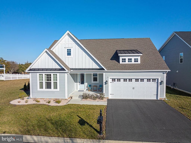 view of front of house featuring a garage, roof with shingles, a front lawn, covered porch, and aphalt driveway