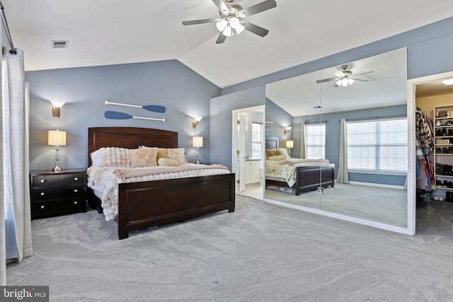 bedroom with lofted ceiling, a closet, light colored carpet, visible vents, and a spacious closet