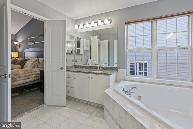 full bathroom with ensuite bathroom, vanity, and a bath