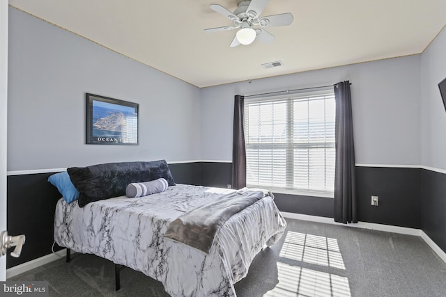 carpeted bedroom with a ceiling fan, visible vents, and baseboards