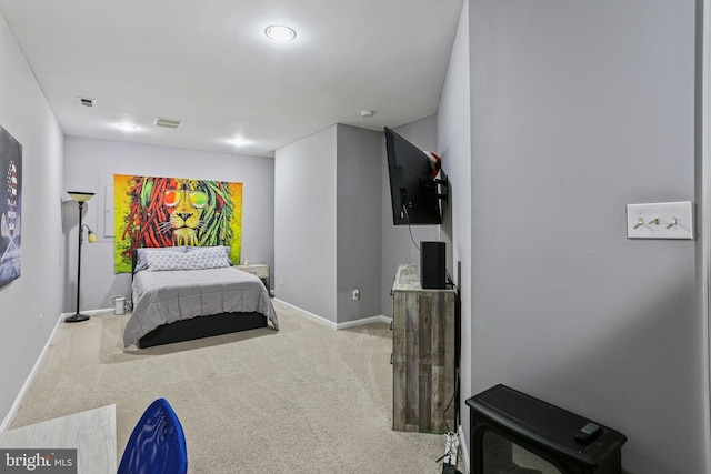 bedroom featuring light carpet, baseboards, and visible vents