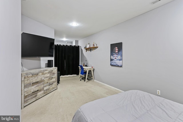 carpeted bedroom with visible vents and baseboards