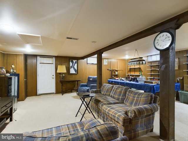 living room with light carpet and wood walls